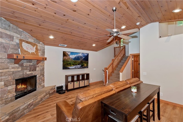 living room featuring wood ceiling, ceiling fan, light hardwood / wood-style flooring, and a fireplace