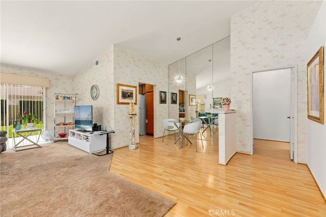 living room with hardwood / wood-style flooring and a towering ceiling