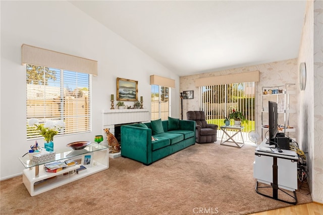 living room featuring carpet flooring and high vaulted ceiling