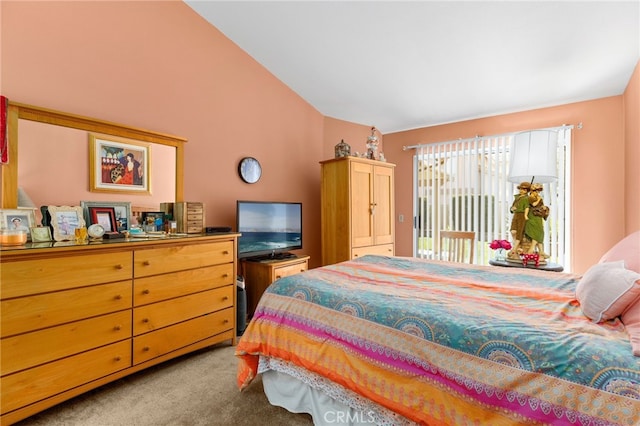 carpeted bedroom featuring access to exterior and vaulted ceiling