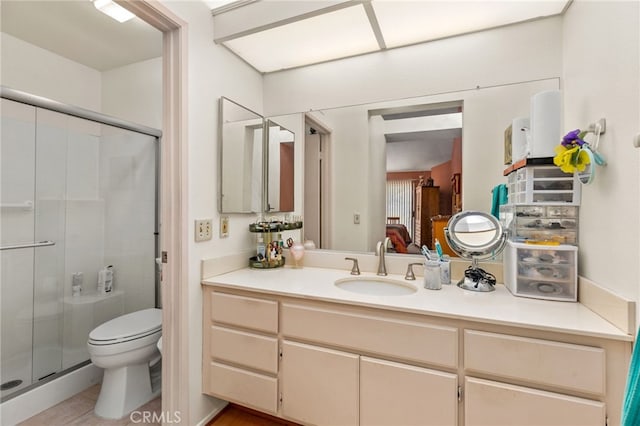 bathroom featuring walk in shower, vanity, and toilet