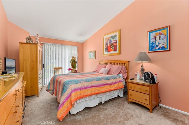 carpeted bedroom featuring vaulted ceiling and access to outside