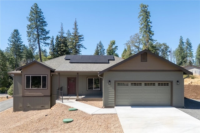 view of front of house with a garage and solar panels