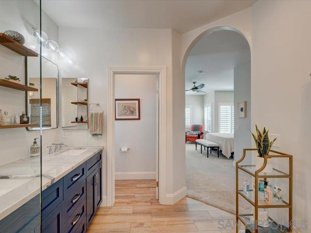 bathroom with ceiling fan, hardwood / wood-style flooring, and vanity