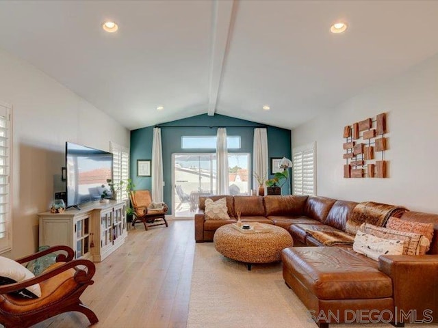 living room featuring light hardwood / wood-style flooring and lofted ceiling with beams