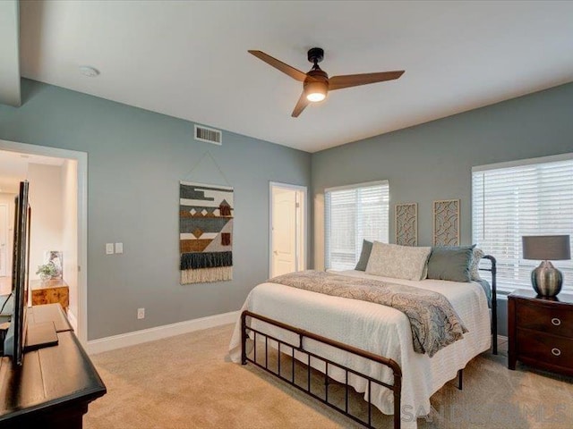 bedroom with ceiling fan and light carpet