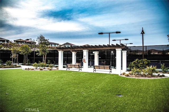 exterior space with a lawn and a pergola