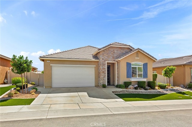 ranch-style house with fence, a garage, concrete driveway, a tile roof, and stucco siding