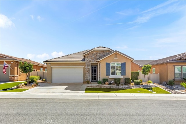 ranch-style home featuring driveway, a garage, stone siding, fence, and stucco siding