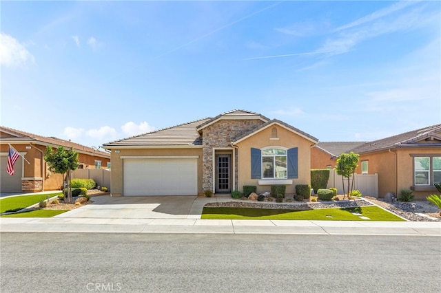 ranch-style house with fence, a tiled roof, a garage, concrete driveway, and stucco siding
