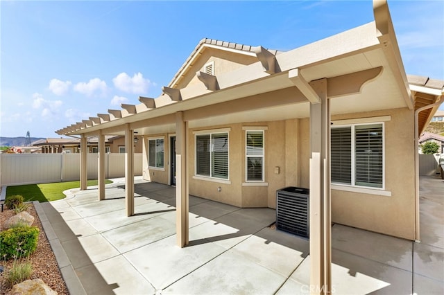 view of patio / terrace with central AC and fence