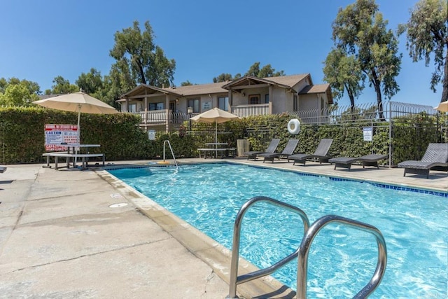 view of swimming pool with a patio