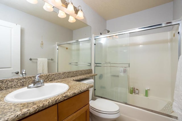 full bathroom with toilet, a textured ceiling, vanity, and shower / bath combination with glass door