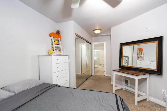 bedroom with ceiling fan, a closet, and light carpet