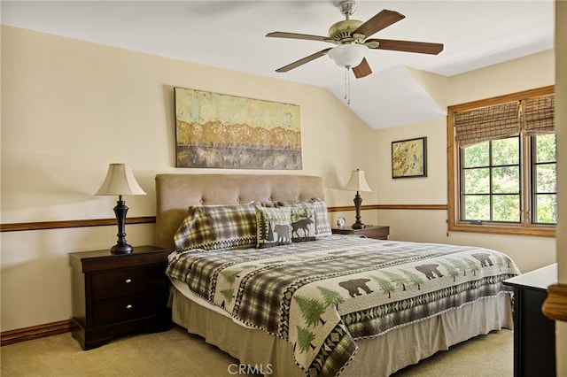 carpeted bedroom featuring vaulted ceiling and ceiling fan