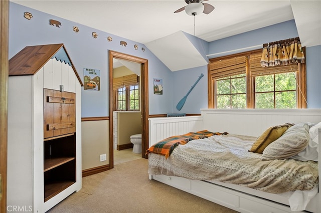 carpeted bedroom featuring ceiling fan, connected bathroom, and vaulted ceiling