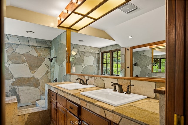 bathroom featuring vanity and a shower