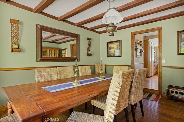 dining area with dark hardwood / wood-style floors and beam ceiling