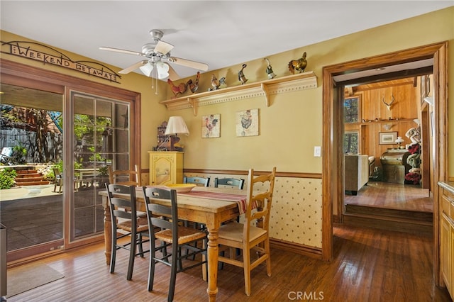 dining space featuring wood-type flooring and ceiling fan