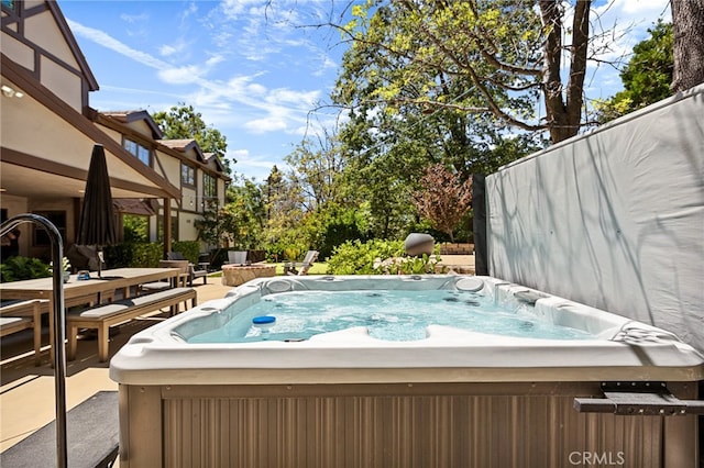 view of pool featuring a patio area and a hot tub