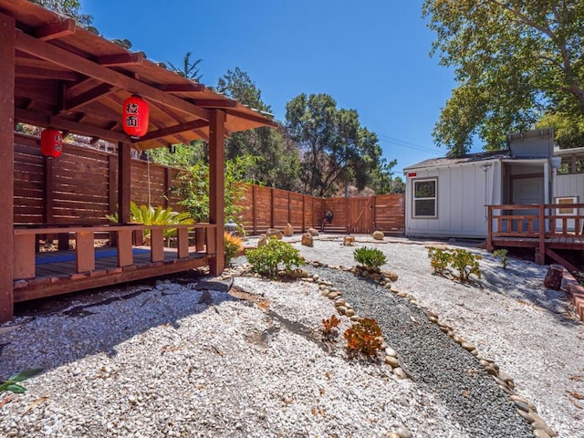 view of yard with an outdoor structure and a deck