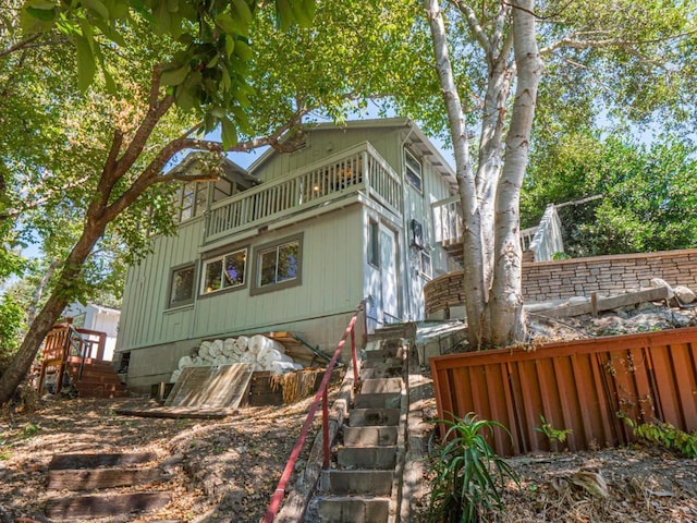 view of side of property with a balcony