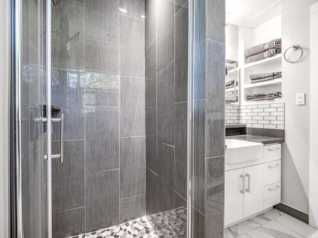 bathroom with vanity and a shower with shower door