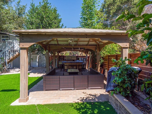 view of patio with an outdoor living space and a gazebo