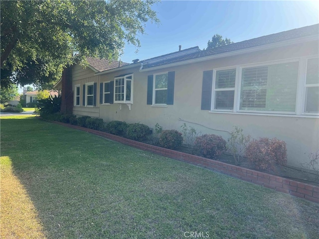 view of side of property with a yard