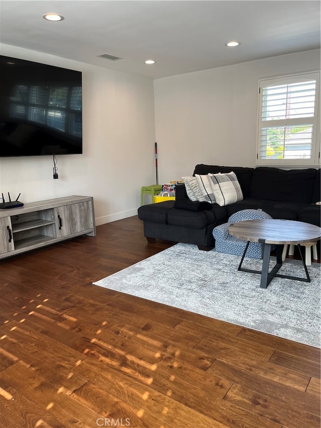 living room with dark hardwood / wood-style flooring