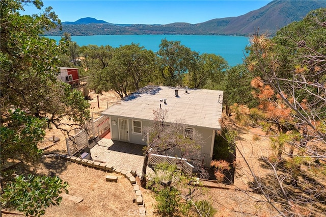 drone / aerial view featuring a water and mountain view