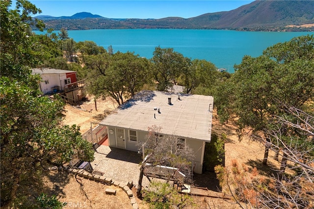 birds eye view of property with a water and mountain view