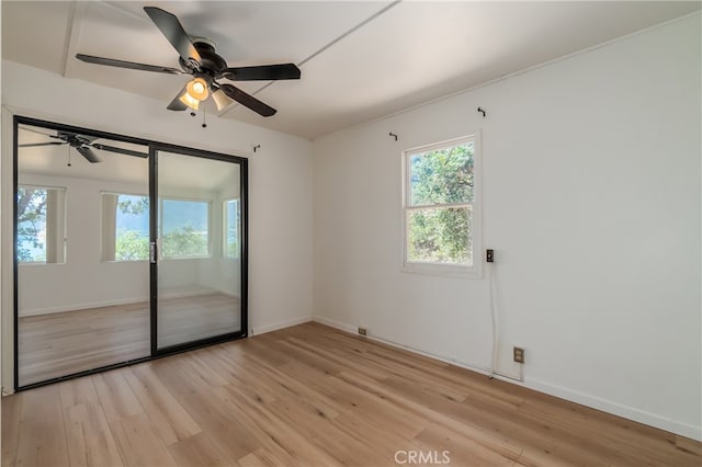 unfurnished room featuring light wood-type flooring and ceiling fan