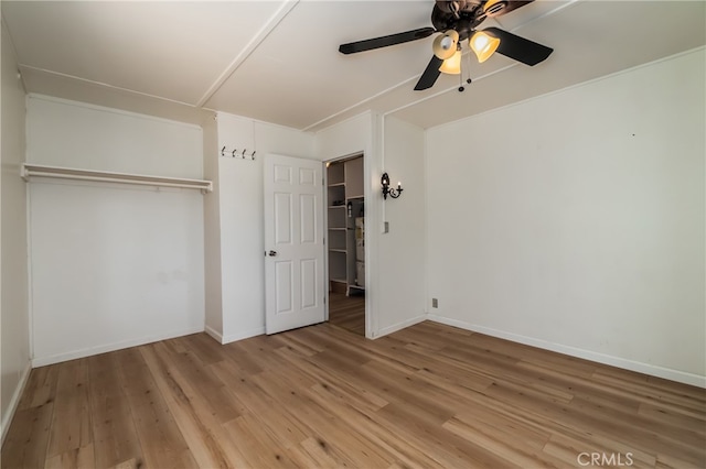 unfurnished bedroom with light hardwood / wood-style floors, ceiling fan, and a closet