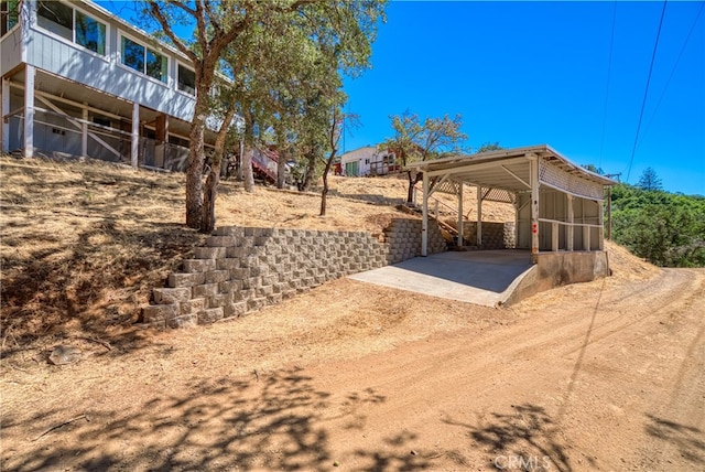 exterior space featuring a carport and a sunroom