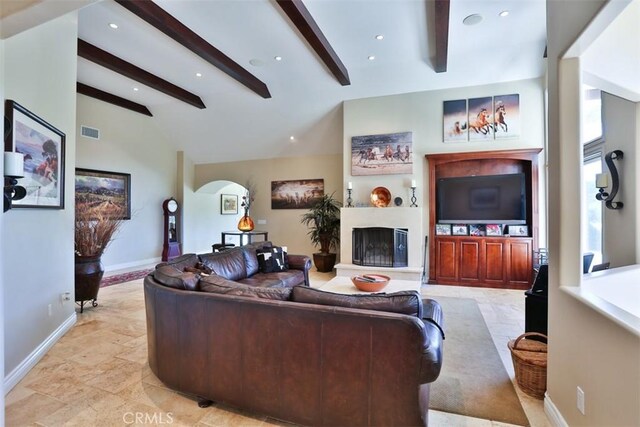 living room with lofted ceiling with beams