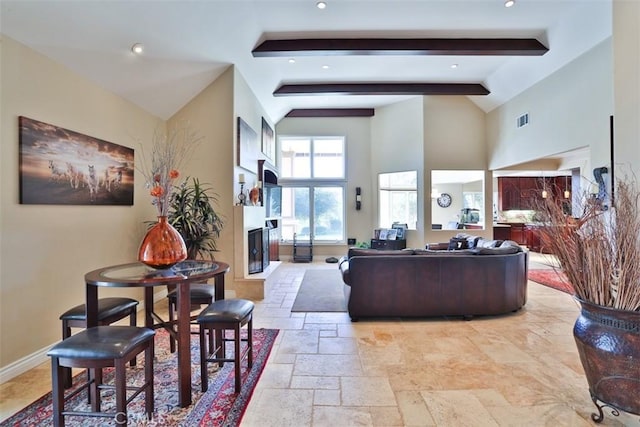 41565 Avenida Conchita, Murrieta, CA 92562 - living area featuring high vaulted ceiling, beam ceiling, stone tile floors, a fireplace, and baseboards