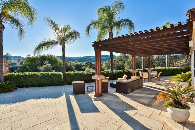 view of patio / terrace featuring a pergola and a mountain view