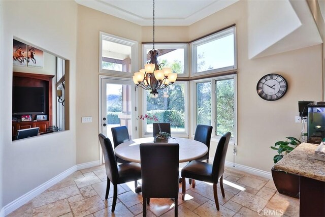 dining room featuring a towering ceiling and a chandelier