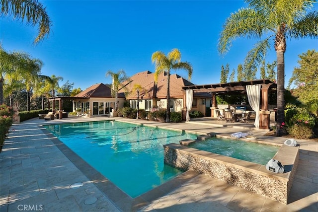 view of swimming pool featuring an in ground hot tub and a patio area