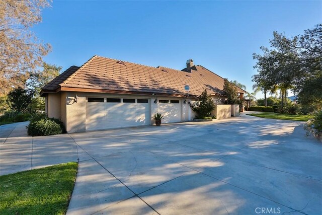 view of side of home featuring a garage