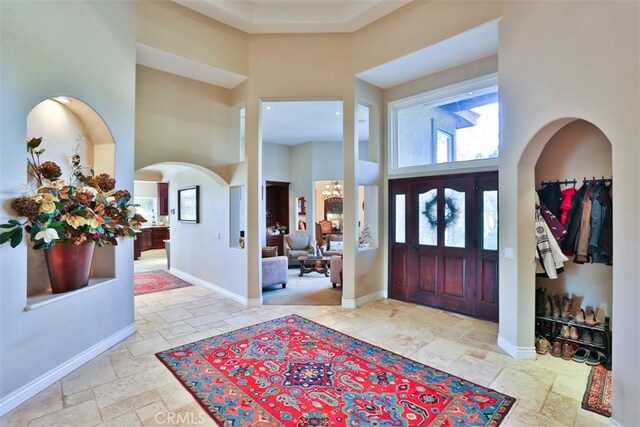 entrance foyer featuring a high ceiling and an inviting chandelier