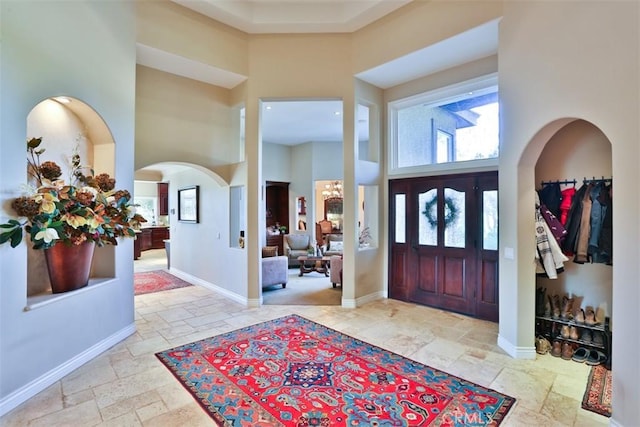 41565 Avenida Conchita, Murrieta, CA 92562 - entrance foyer featuring a towering ceiling, stone tile flooring, and baseboards