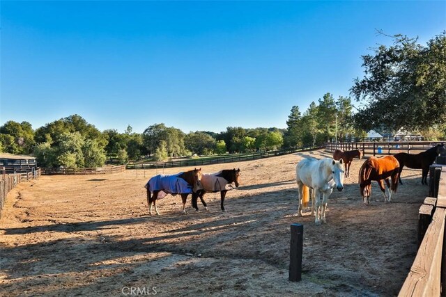 view of horse barn with a rural view