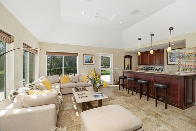 41565 Avenida Conchita, Murrieta, CA 92562 - living area with bar, high vaulted ceiling, and light stone finish floors