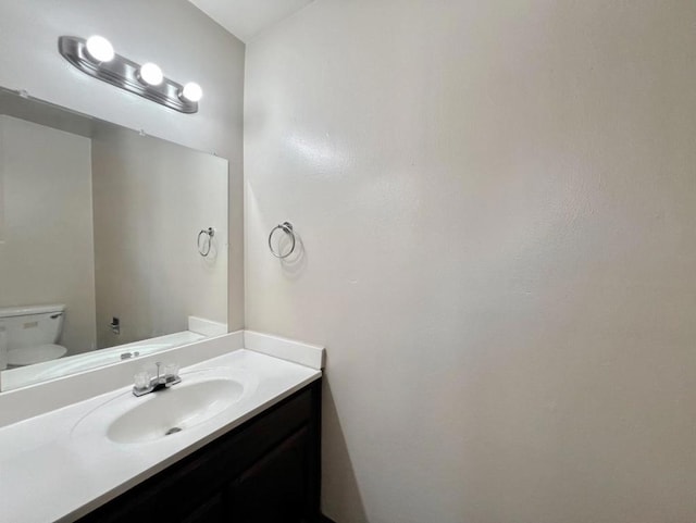 bathroom with toilet and vanity