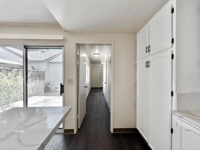 hall with dark wood-type flooring