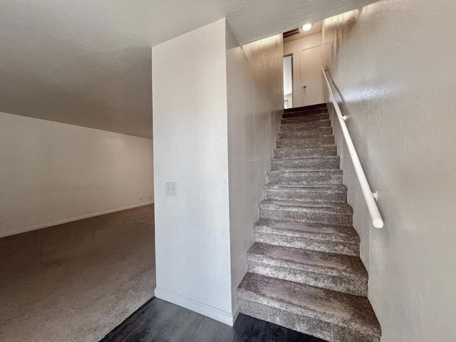 stairs featuring hardwood / wood-style flooring