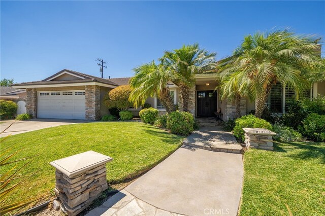 view of front of home featuring a garage and a front lawn