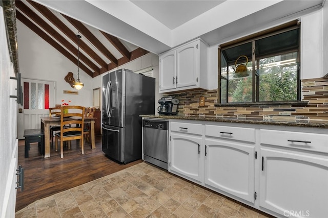 kitchen featuring dark stone counters, appliances with stainless steel finishes, backsplash, and white cabinetry